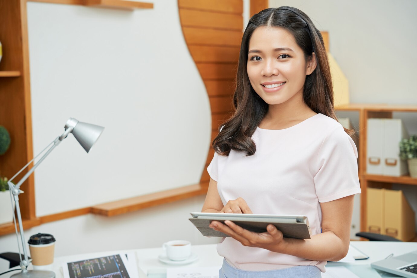 contemporary-businesswoman-with-tablet-smiling-camera_1098-20857